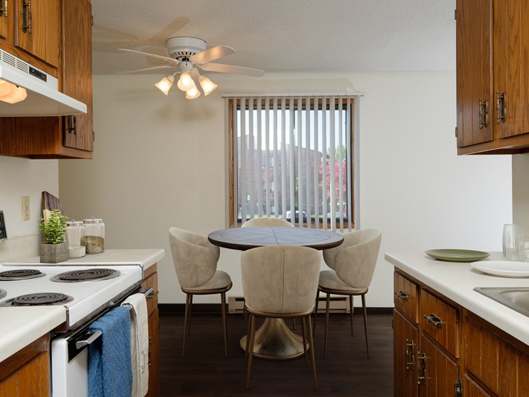 a kitchen and dining room with a table and chairs. Fargo, ND Countryside Apartments